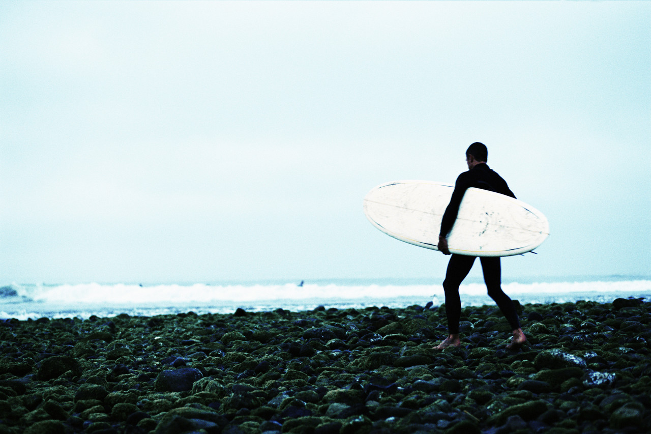 Surfer Heading Towards Waves